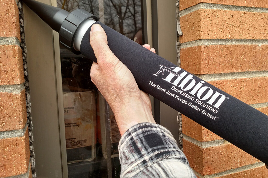 Photo of Man using Albion Sleeve on Caulk Gun